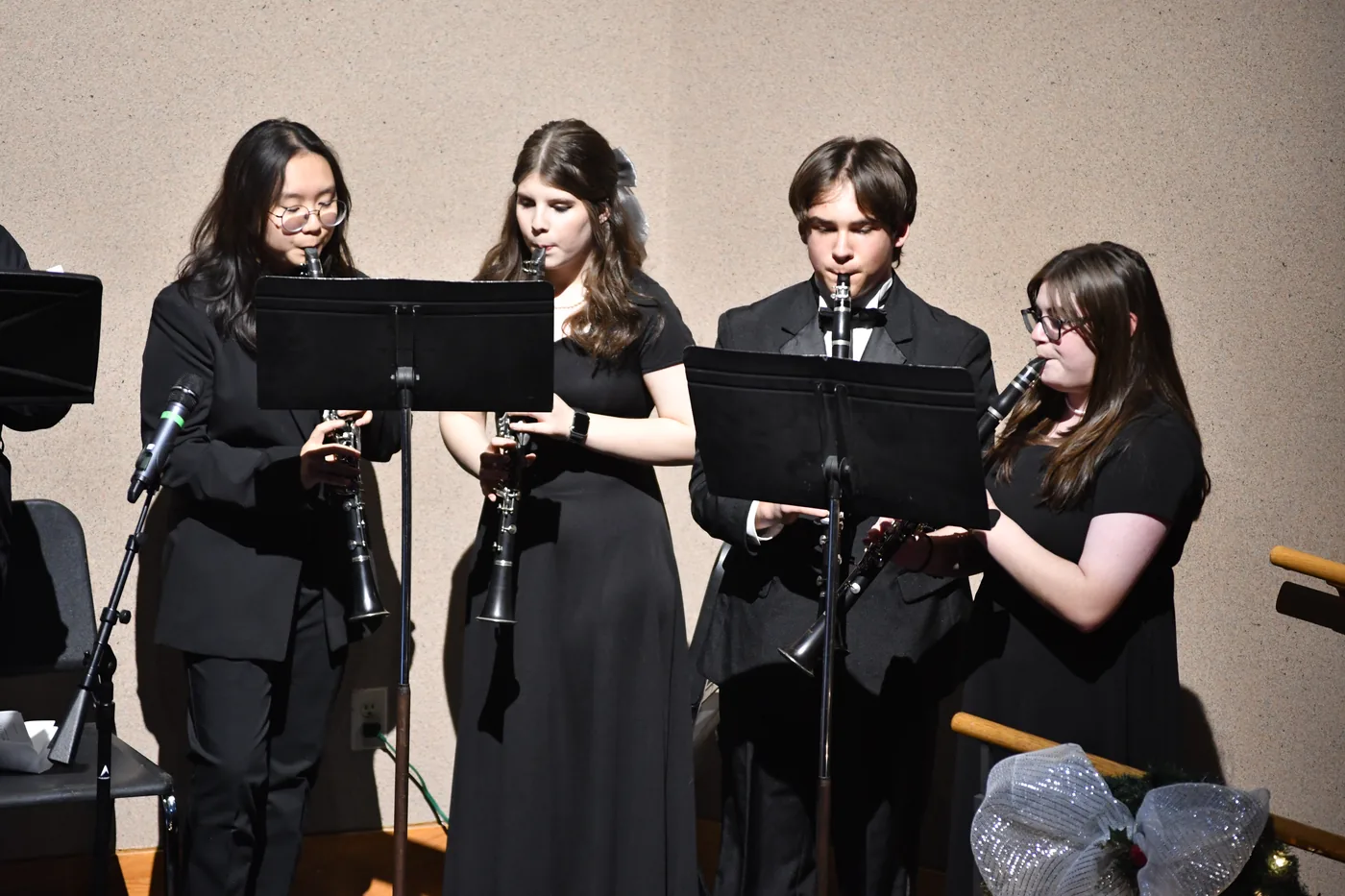 Four South Lyon students performing as a clarinet ensemble onstage in 2025