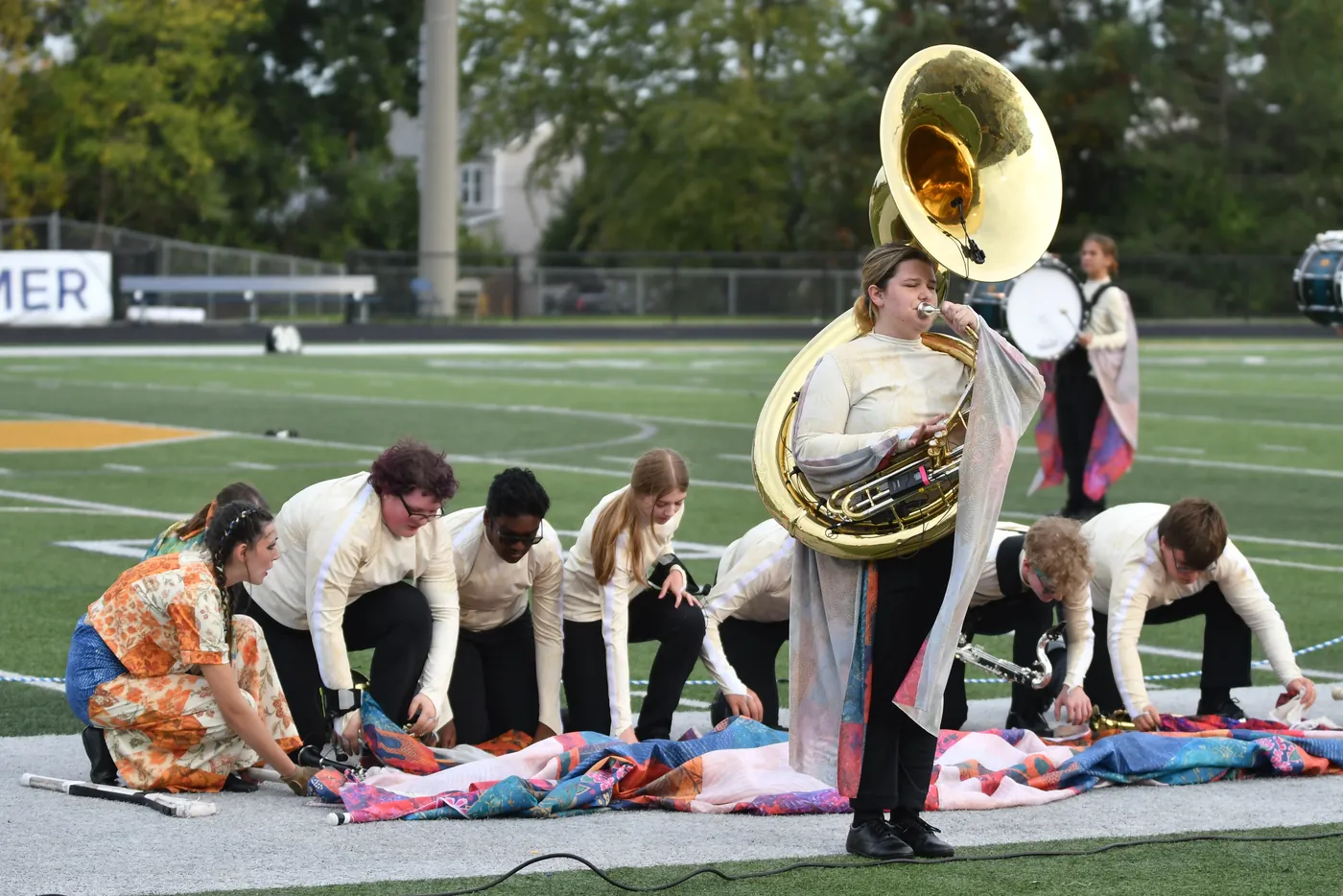 South Lyon students preparing a large field prop together before a performance
